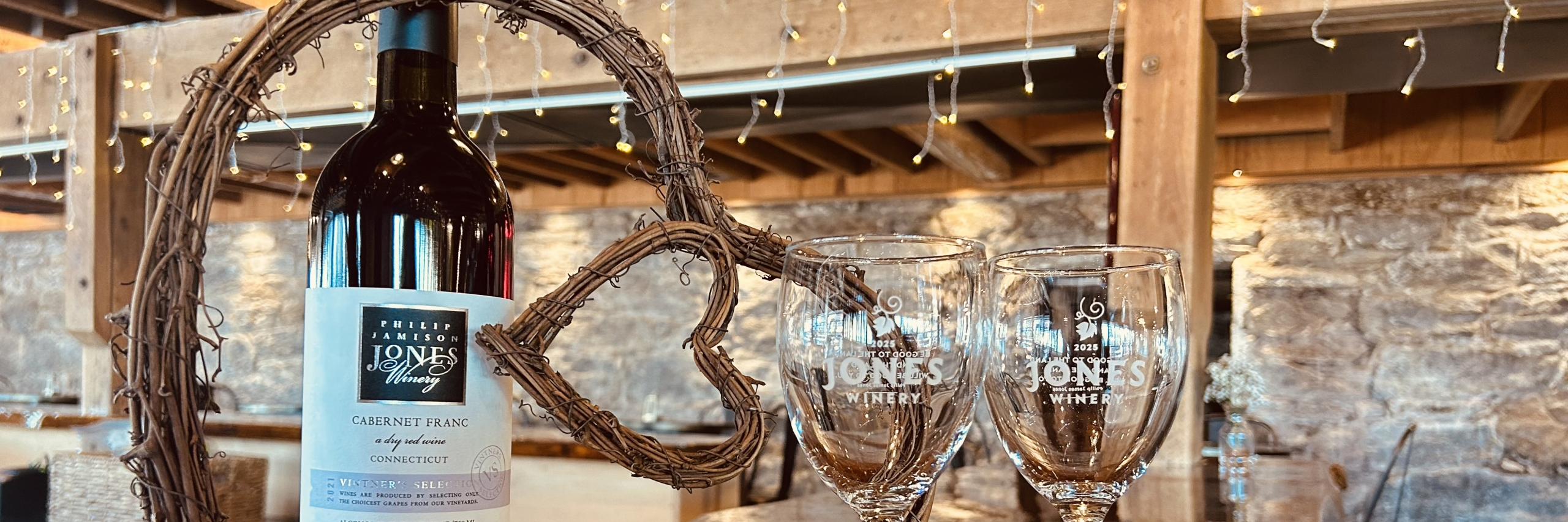 Winery Valentine's Day with wine glasses alongside a heart wreath