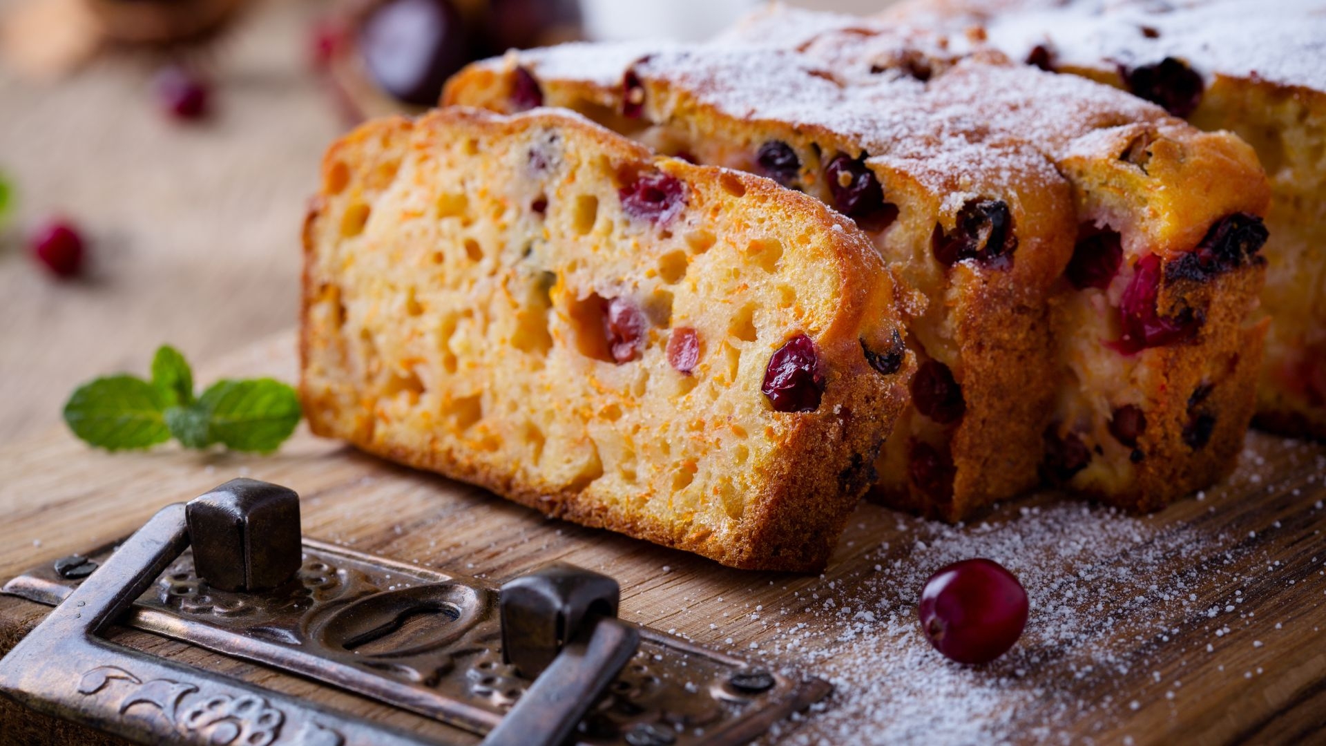 sliced Pumpkin Cranberry Tea Bread on a cutting board