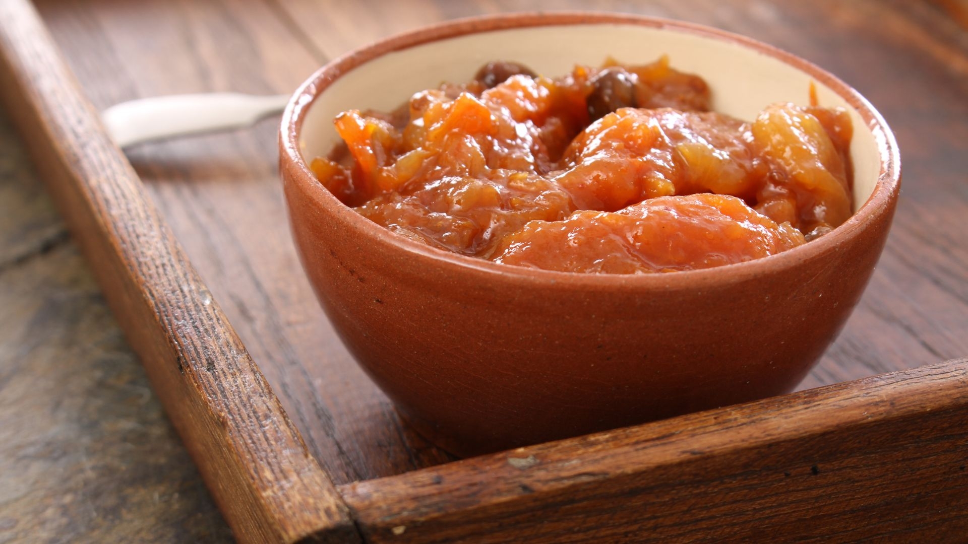 a bowl on a serving tray of Squash and Apricot Chutney