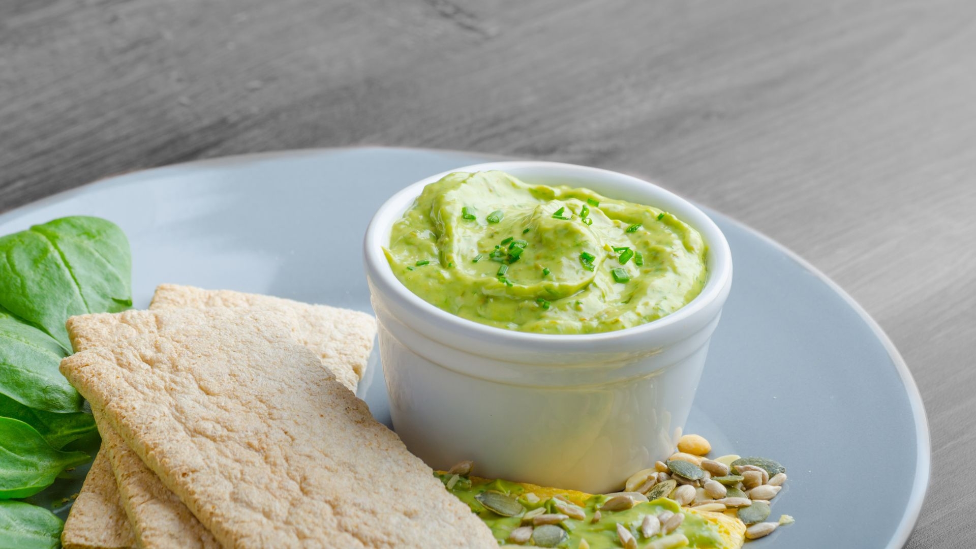 dip in small bowl on serving plate with pita bread