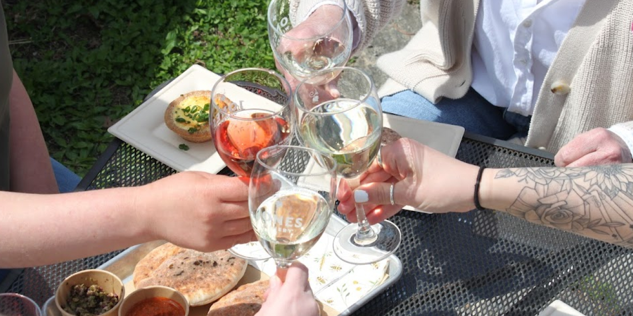 Glasses together over a plate offering.